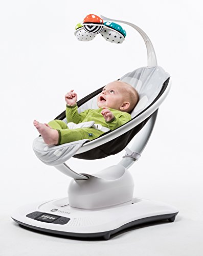 laughing baby lying in mamaroo playing with mobile